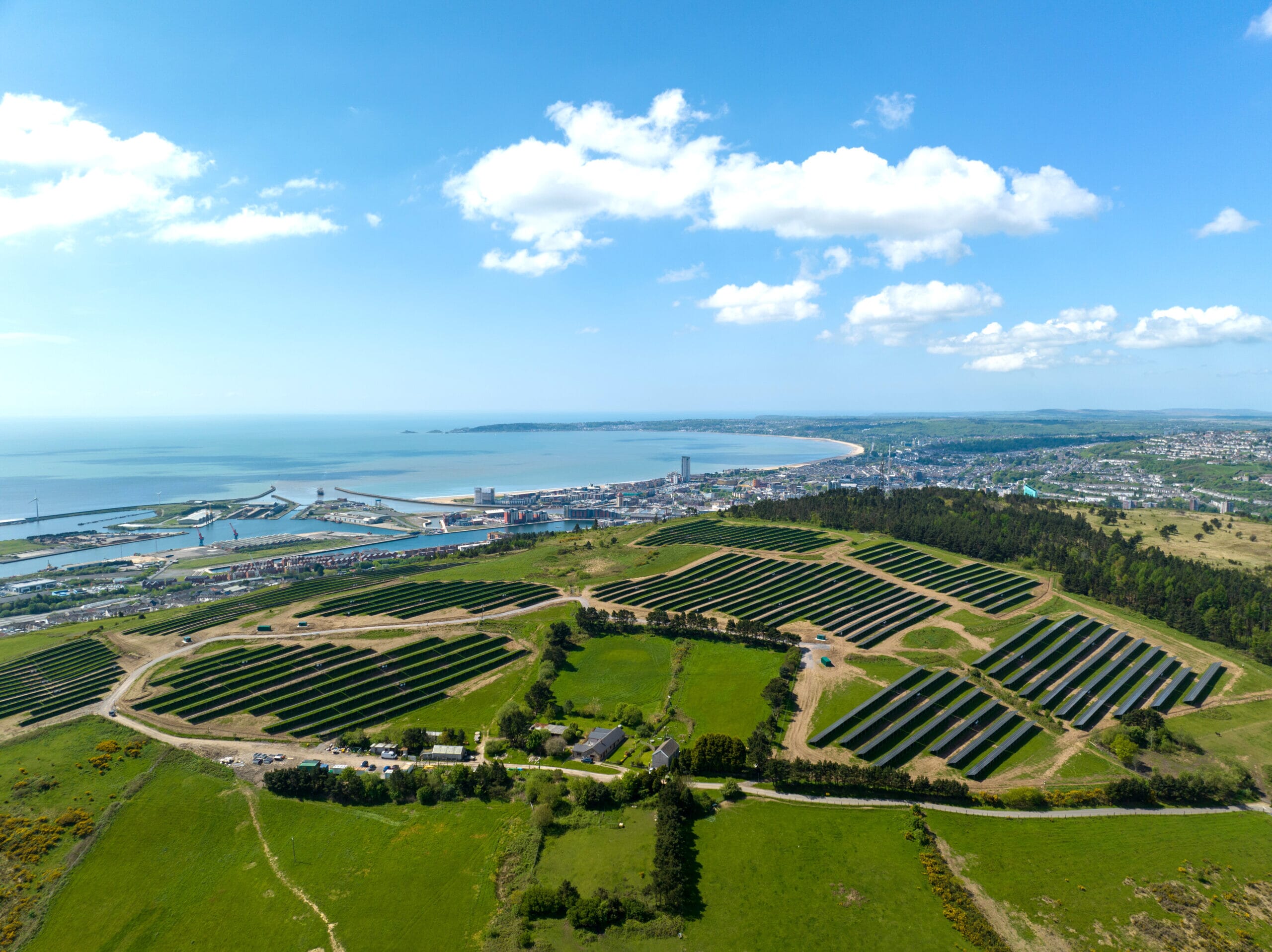 An aerial view of Carn Nicholas with Swansea in the background